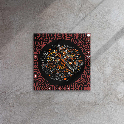 Square decorative dark red and black panel with abstract design on a textured wall