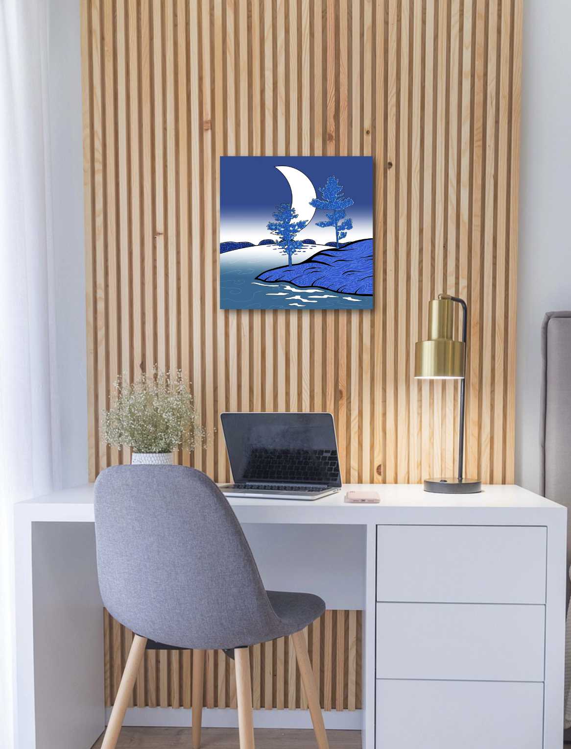 Modern office setup with a desk, chair, laptop, & decorative stylistic wall art.