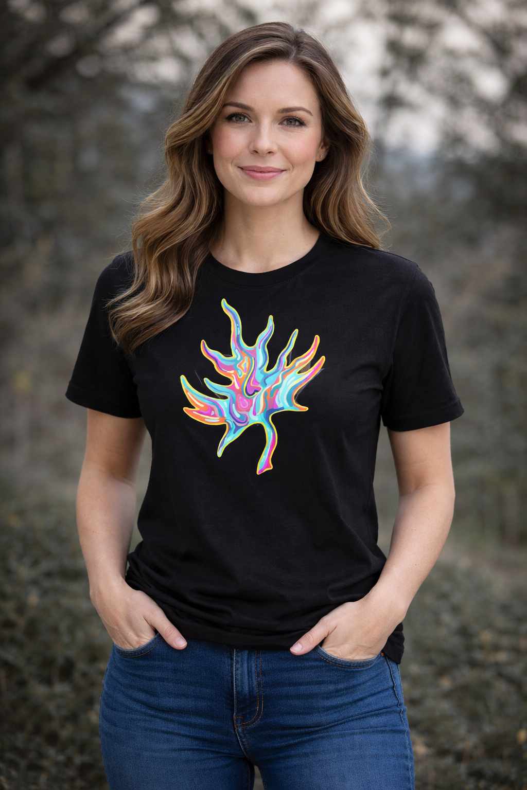 Woman wearing a black t-shirt with a colourful Psychedelic Maple abstract design outdoors.